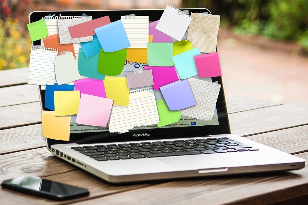 Laptop covered in sticky notes